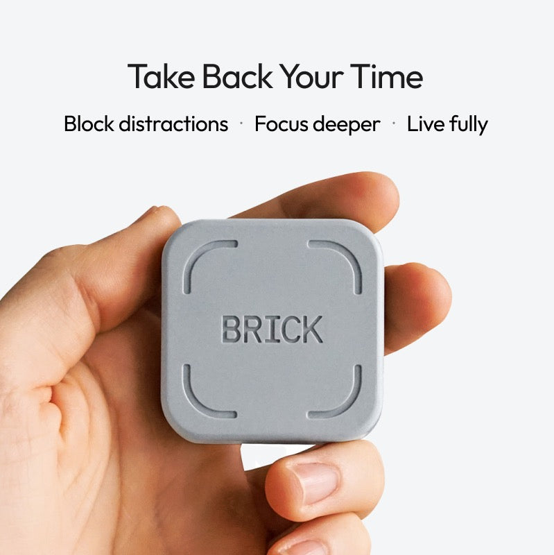 Hand holding a gray 'BRICK' device with text about time management on a white background