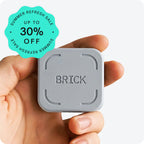 Hand holding a gray 'BRICK' device with a summer refresh sale badge on a white background
